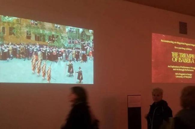 Two images projected onto a gallery wall.