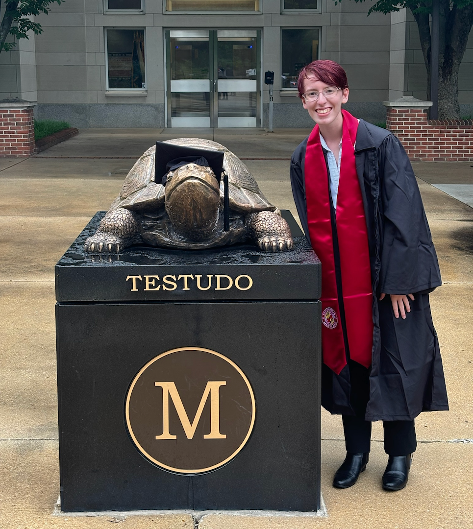 Graduate Ally Rizzo poses with the Testudo statue 